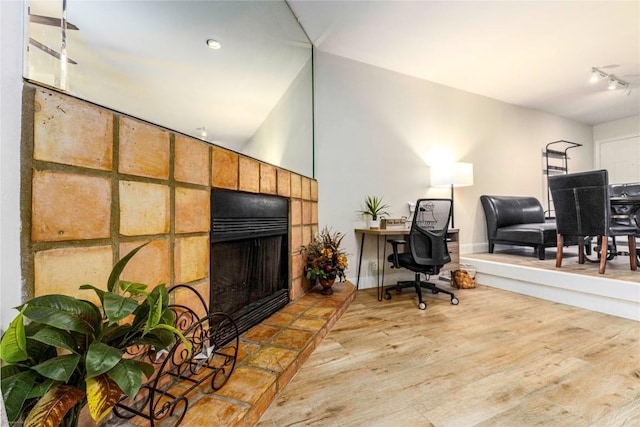 1135 Barton Hills Dr Unit 160, Austin, TX 78704 - office space featuring wood finished floors, a fireplace with raised hearth, baseboards, and track lighting