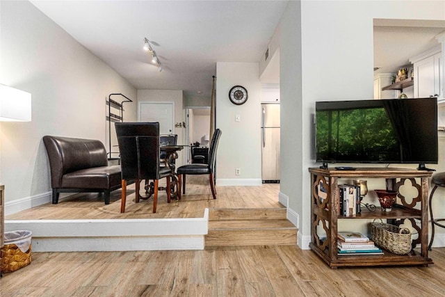 1135 Barton Hills Dr Unit 160, Austin, TX 78704 - living room with light wood-style floors, baseboards, and track lighting