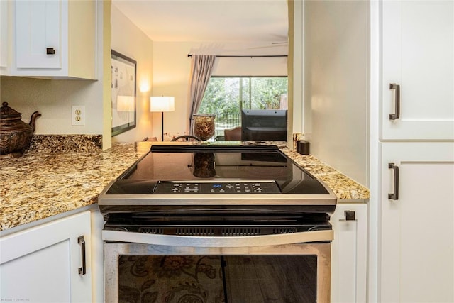 1135 Barton Hills Dr Unit 160, Austin, TX 78704 - kitchen with range with electric cooktop, white cabinets, and light stone countertops