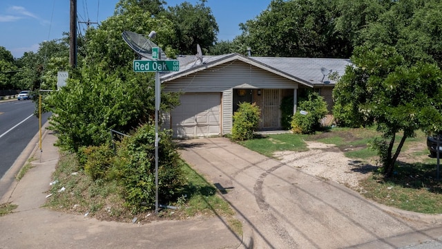 100 Red Oak Cir, Austin, TX 78753 - view of front of house featuring an attached garage, brick siding, and driveway