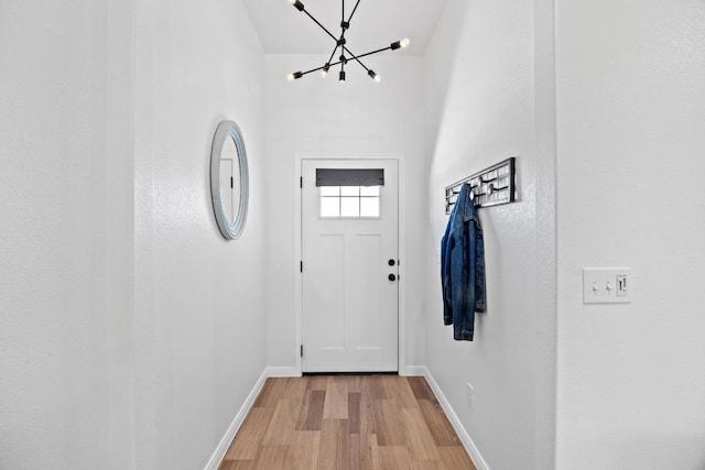 2545 Belle Hubbard Trl, Belton, TX 76513 - doorway to outside with baseboards, light wood-style flooring, and a chandelier