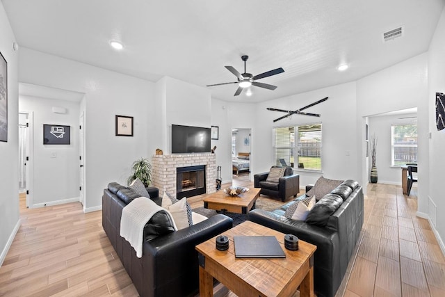 2545 Belle Hubbard Trl, Belton, TX 76513 - living room featuring ceiling fan, light wood-type flooring, a brick fireplace, baseboards, and recessed lighting