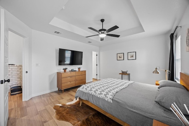 2545 Belle Hubbard Trl, Belton, TX 76513 - bedroom with a raised ceiling, light wood-type flooring, baseboards, and a ceiling fan