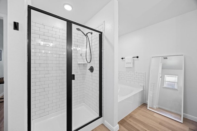 2545 Belle Hubbard Trl, Belton, TX 76513 - bathroom featuring a bath, a shower stall, wood finished floors, and baseboards