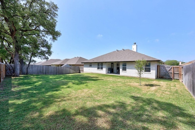 2545 Belle Hubbard Trl, Belton, TX 76513 - back of house featuring brick siding, a chimney, and a gate