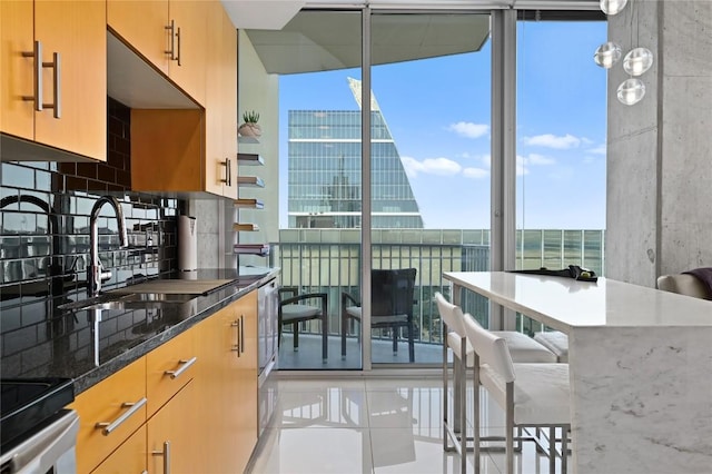 360 Nueces St Unit 3602, Austin, TX 78701 - kitchen featuring a sink, light tile patterned floors, decorative backsplash, dark stone countertops, and floor to ceiling windows