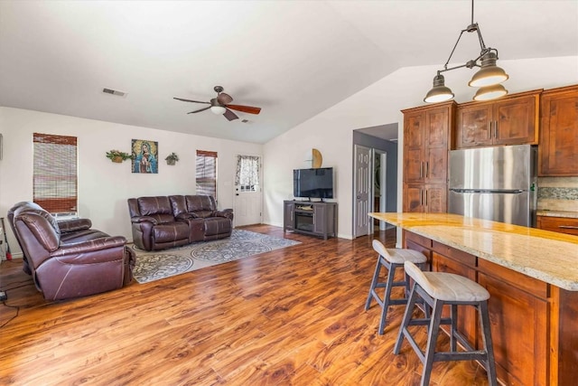 178 Balch Rd, Elgin, TX 78621 - living area featuring wood finished floors, lofted ceiling, and a ceiling fan