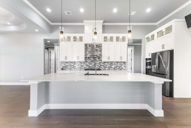 178 Balch Rd, Elgin, TX 78621 - kitchen with appliances with stainless steel finishes, wall chimney range hood, dark wood-style floors, crown molding, and a large island with sink