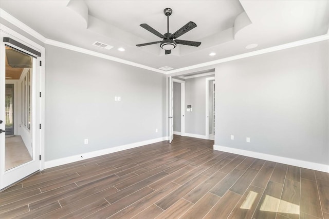 178 Balch Rd, Elgin, TX 78621 - empty room featuring a tray ceiling, a ceiling fan, recessed lighting, dark wood-type flooring, and ornamental molding