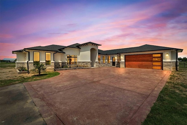 178 Balch Rd, Elgin, TX 78621 - view of front of property with stone siding, stucco siding, an attached garage, and concrete driveway