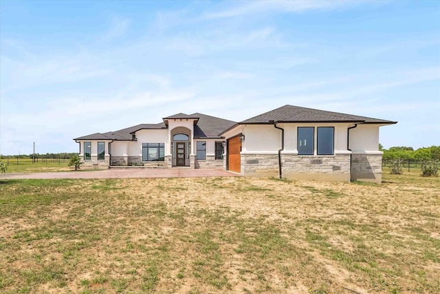 178 Balch Rd, Elgin, TX 78621 - view of front of house with stucco siding, stone siding, and a front lawn
