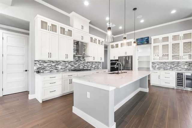 178 Balch Rd, Elgin, TX 78621 - kitchen featuring stainless steel appliances, wall chimney exhaust hood, beverage cooler, crown molding, and backsplash