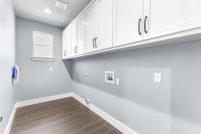 178 Balch Rd, Elgin, TX 78621 - washroom featuring cabinet space, hookup for an electric dryer, hookup for a washing machine, baseboards, and dark wood-type flooring
