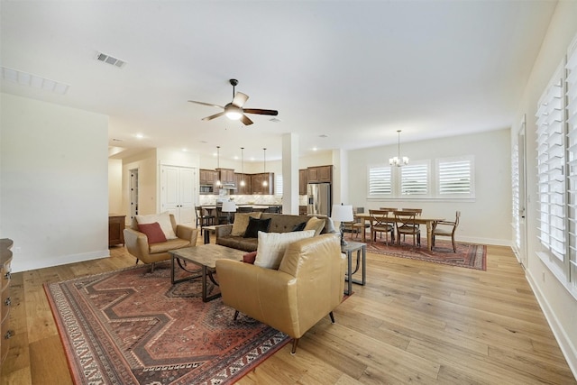 192 Call Dr, Austin, TX 78737 - living area with ceiling fan, light wood-type flooring, a chandelier, and baseboards