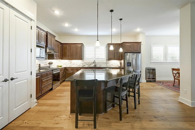 192 Call Dr, Austin, TX 78737 - kitchen with stainless steel appliances, a sink, backsplash, plenty of natural light, and recessed lighting