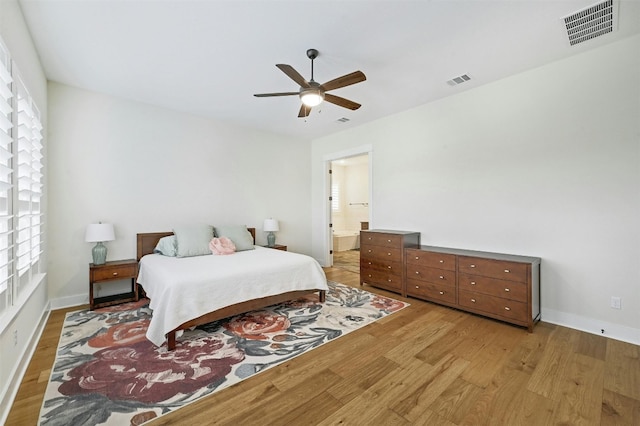 192 Call Dr, Austin, TX 78737 - bedroom with light wood-style floors, ensuite bathroom, a ceiling fan, and baseboards