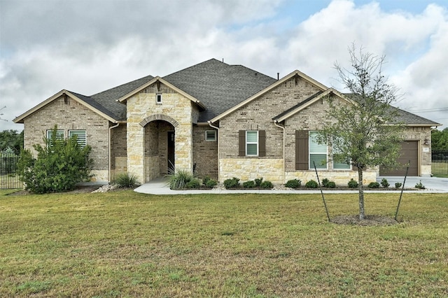 192 Call Dr, Austin, TX 78737 - french provincial home featuring stone siding, a garage, and roof with shingles