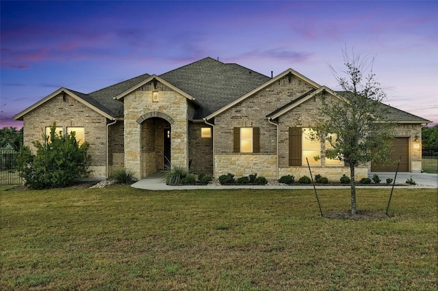 192 Call Dr, Austin, TX 78737 - french country home with a garage, stone siding, roof with shingles, and brick siding