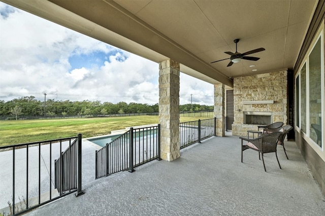 192 Call Dr, Austin, TX 78737 - view of patio featuring a ceiling fan and an outdoor stone fireplace