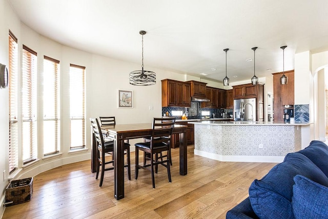 110 Saint Richie Ln, Austin, TX 78737 - dining space with light wood finished floors and arched walkways