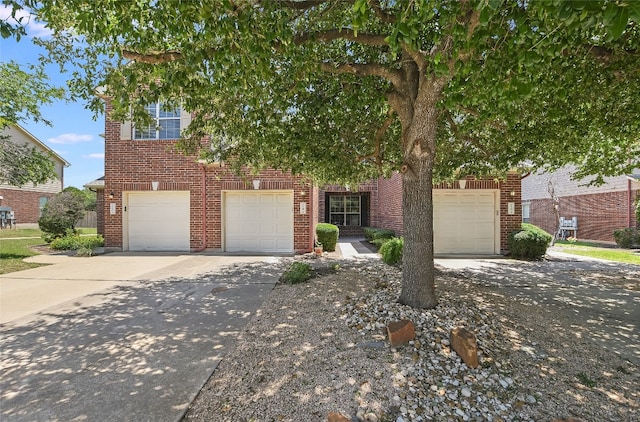 14 Verde Ranch Loop, Leander, TX 78641 - obstructed view of property featuring concrete driveway, brick siding, and an attached garage