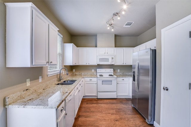 14 Verde Ranch Loop, Leander, TX 78641 - kitchen with white appliances, white cabinets, light stone counters, and wood finished floors