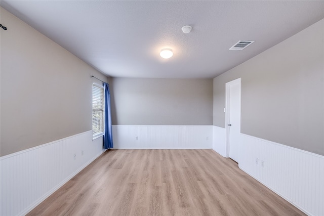 14 Verde Ranch Loop, Leander, TX 78641 - unfurnished room featuring a wainscoted wall and wood finished floors