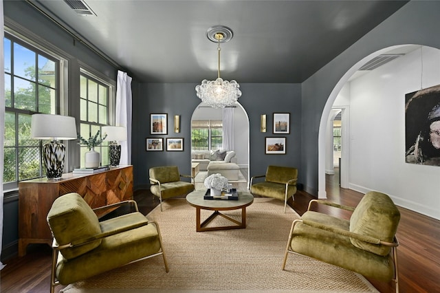 1712 Hartford Rd, Austin, TX 78703 - sitting room with arched walkways, wood finished floors, a chandelier, and baseboards