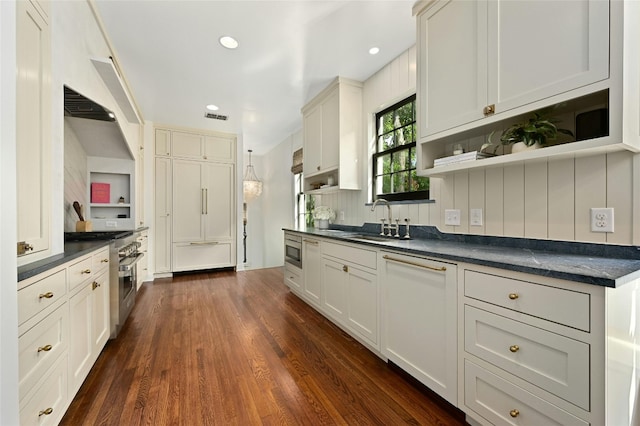 1712 Hartford Rd, Austin, TX 78703 - kitchen with open shelves, dark countertops, a sink, dark wood finished floors, and stainless steel microwave