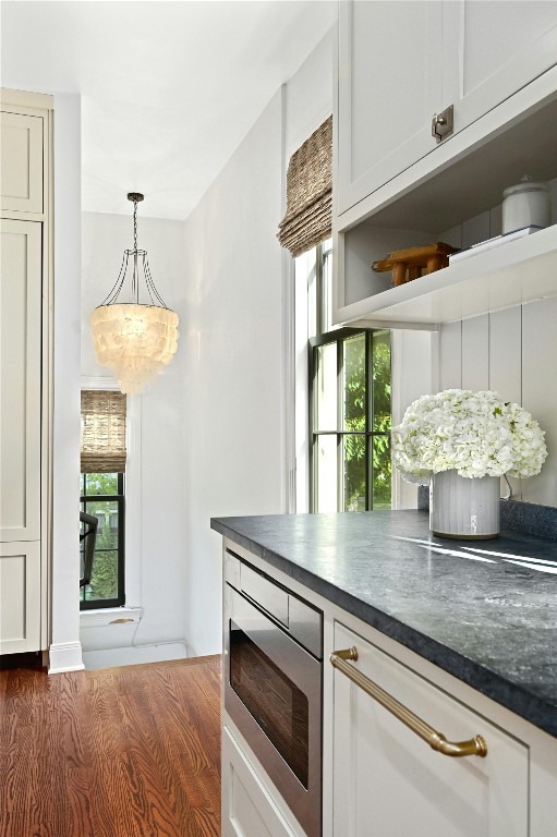 1712 Hartford Rd, Austin, TX 78703 - bar area featuring stainless steel microwave, hanging light fixtures, and dark wood finished floors
