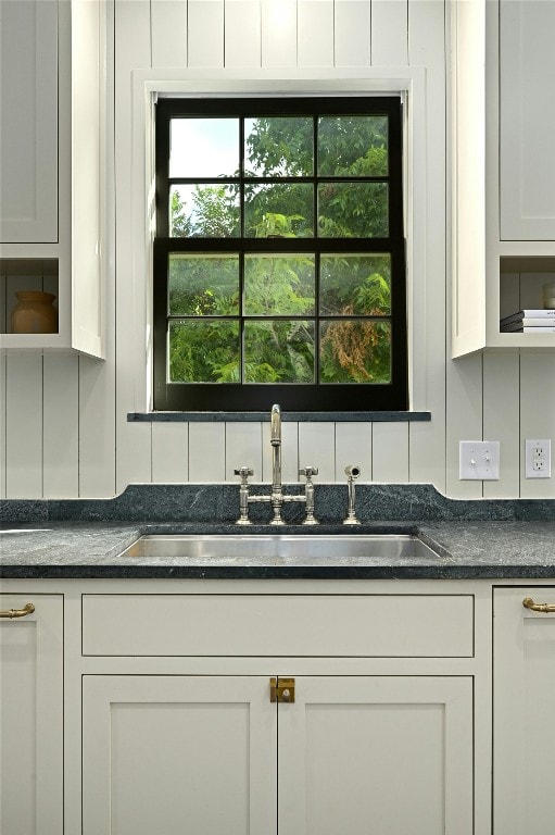 1712 Hartford Rd, Austin, TX 78703 - detailed view of a sink, white cabinets, and dark stone countertops