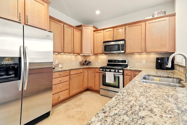 12808 Venice Ln, Austin, TX 78750 - kitchen with appliances with stainless steel finishes, a sink, tasteful backsplash, light stone countertops, and recessed lighting