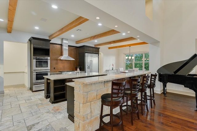 1101 Sprague Ln, West Lake Hills, TX 78746 - kitchen with a spacious island, wall chimney range hood, appliances with stainless steel finishes, beamed ceiling, and recessed lighting