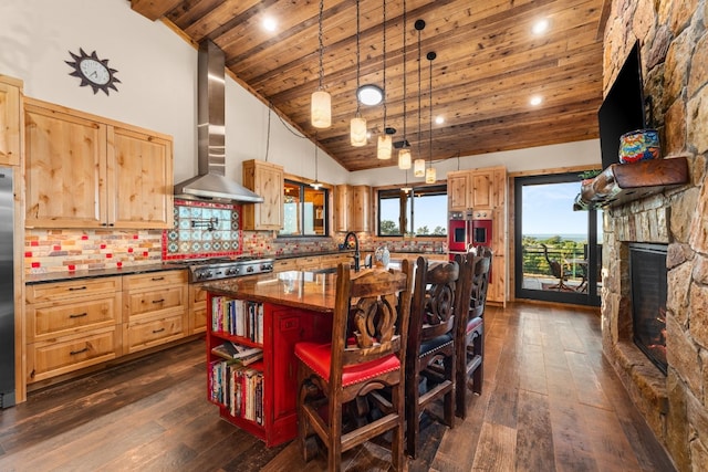281 Cedar Mountain Dr, Marble Falls, TX 78654 - kitchen with wall chimney exhaust hood, stainless steel gas stovetop, dark wood-style flooring, wood ceiling, and a kitchen bar