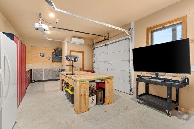 281 Cedar Mountain Dr, Marble Falls, TX 78654 - garage with a workshop area, freestanding refrigerator, and a garage door opener