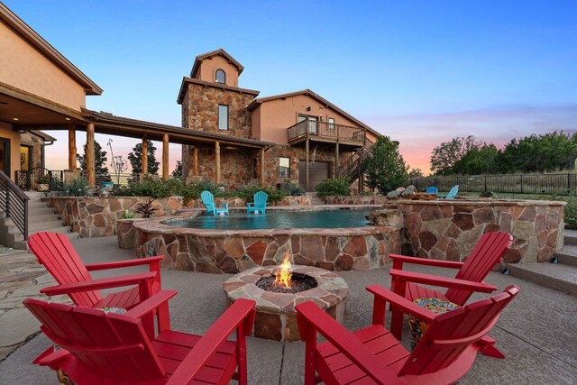 281 Cedar Mountain Dr, Marble Falls, TX 78654 - patio terrace at dusk featuring an outdoor fire pit, a patio area, and stairway