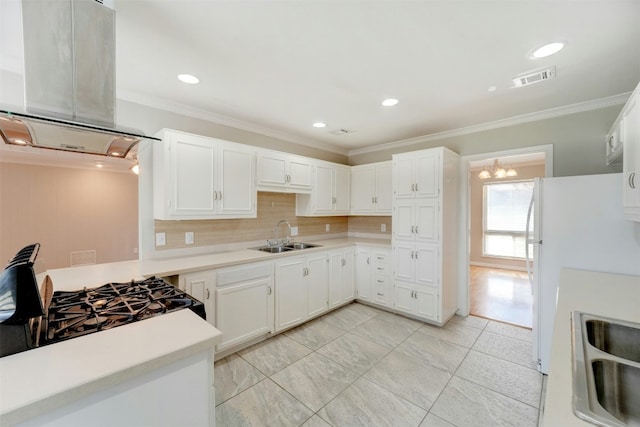 4020 Far W Blvd, Austin, TX 78731 - kitchen featuring island range hood, freestanding refrigerator, light countertops, tasteful backsplash, and white cabinets