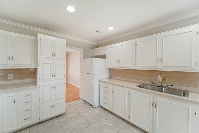 4020 Far W Blvd, Austin, TX 78731 - kitchen featuring freestanding refrigerator, decorative backsplash, white cabinets, crown molding, and light countertops