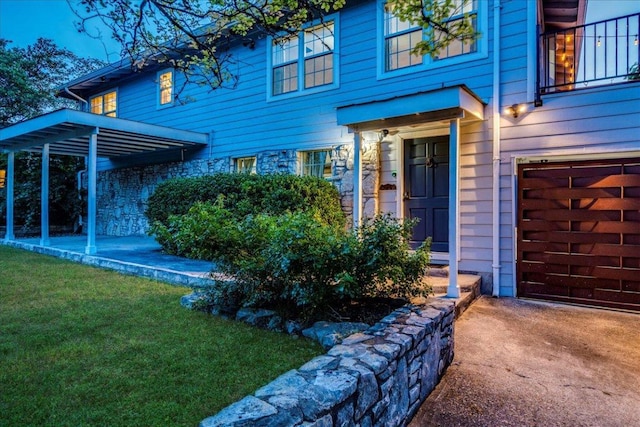8204 Williamson Creek Dr, Austin, TX 78736 - doorway to property with an attached garage, stone siding, a yard, a balcony, and concrete driveway
