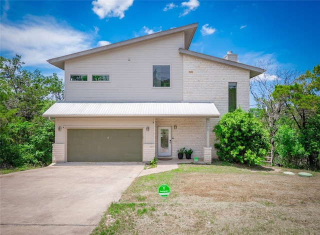14410 Hunters Pass, Austin, TX 78734 - view of front of property featuring a chimney, an attached garage, concrete driveway, and brick siding