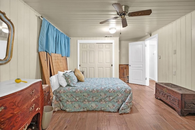 217 S Wilson St, San Marcos, TX 78666 - bedroom with wood finished floors, wood walls, ceiling fan, a closet, and wooden ceiling