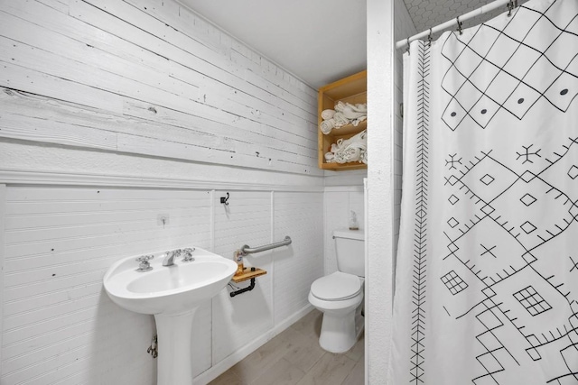 217 S Wilson St, San Marcos, TX 78666 - bathroom featuring wooden walls and a shower with curtain