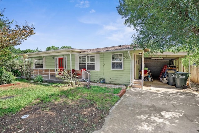 217 S Wilson St, San Marcos, TX 78666 - ranch-style home featuring driveway, a porch, an attached carport, and an attached garage