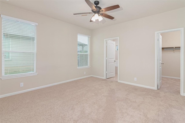 466 Sand Trl, New Braunfels, TX 78130 - unfurnished bedroom featuring a walk in closet, light colored carpet, baseboards, a closet, and ensuite bath