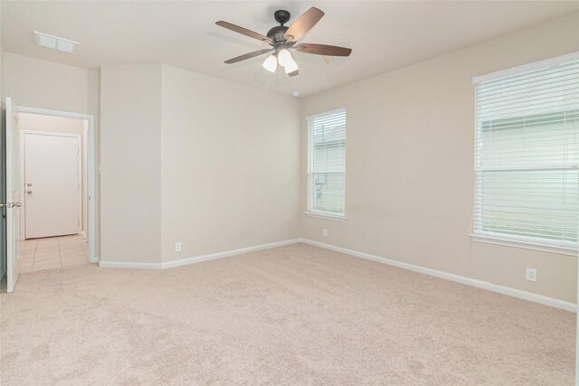 466 Sand Trl, New Braunfels, TX 78130 - spare room featuring light carpet, ceiling fan, and baseboards