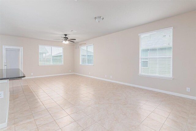 466 Sand Trl, New Braunfels, TX 78130 - empty room with a ceiling fan, baseboards, and light tile patterned flooring