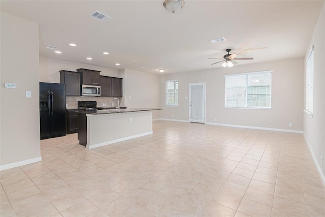 466 Sand Trl, New Braunfels, TX 78130 - kitchen featuring black refrigerator with ice dispenser, stainless steel microwave, range, a ceiling fan, and a sink