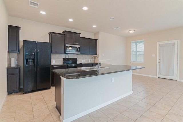 466 Sand Trl, New Braunfels, TX 78130 - kitchen featuring black appliances, a sink, dark countertops, tasteful backsplash, and light tile patterned flooring