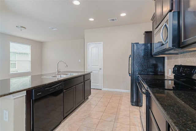 466 Sand Trl, New Braunfels, TX 78130 - kitchen with black appliances, a sink, an island with sink, light tile patterned flooring, and backsplash