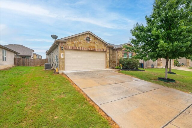 466 Sand Trl, New Braunfels, TX 78130 - view of front of home with central AC unit, concrete driveway, an attached garage, and stone siding